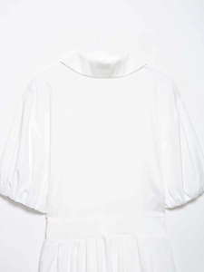 Detail view of white shirt dress featuring puff sleeves and an elastic gathered waistline