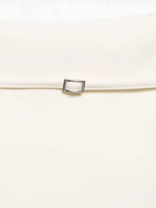 Detail view of high waist white A-line skirt featuring silver rectangular metal buckle belt