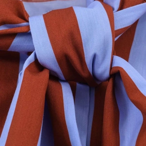 Detailed macro view of the blue and red striped cotton fabric texture with a knotted bow