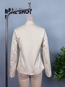 Rear view of sleek ivory satin blazer featuring a tailored waist and structured shoulders