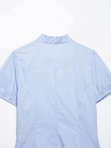 Detailed back view of a light blue poplin shirt with high collar and shoulder seam