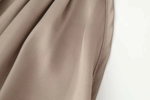 Detailed view of the khaki satin fabric showing high-quality stitching and smooth texture