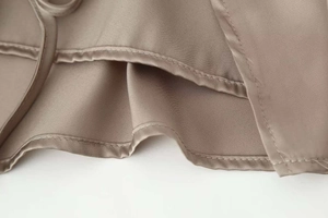 Detailed view of high-quality satin fabric texture and neat hem stitching of this elegant set