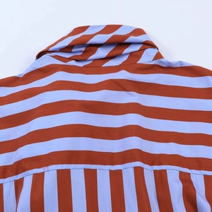 Close-up of contrast orange and blue striped shirt showing fabric seams and detail