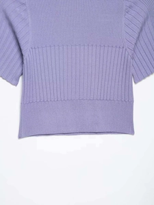 Close-up of lilac ribbed knit top showing soft texture and detailed hemline design