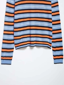 Detail view of the colorful horizontal stripes on this loose casual knit sweater