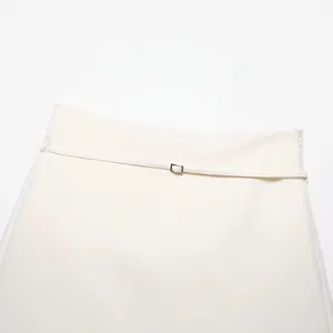 Minimalist white high waist A-line skirt with thin belt and silver buckle detail