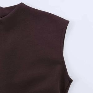 Close-up of the mock neck and seamless shoulder stitching on a brown lace mini dress