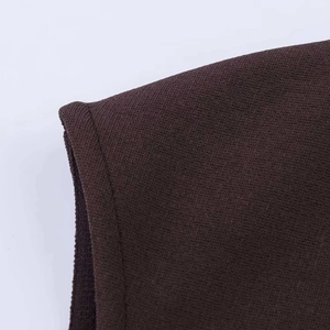 Close-up of shoulder seam and fine knit texture on a dark brown elastic lace dress