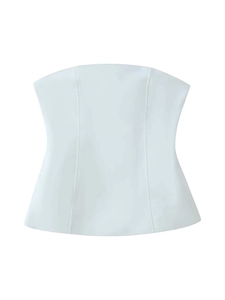 Detailed view of the white strapless top featuring vertical seams and a flared hemline