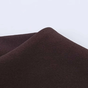 Close-up of the high-quality dark brown stretch knit fabric with dense ribbed texture