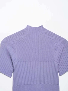 Detail of light purple ribbed knit top showing the semi-high collar and shoulder texture