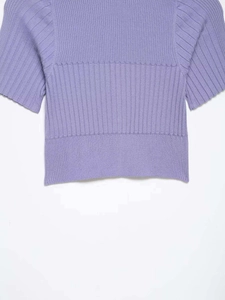 Close-up of lavender ribbed knit top showing smooth hem and fine sleeve stitching