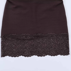 Detailed view of the dark brown knitted dress hem featuring delicate scalloped lace trim