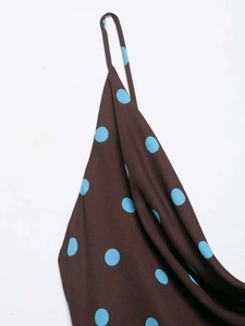 Detailed macro shot of vintage polka dot dress fabric with blue dots and thin straps