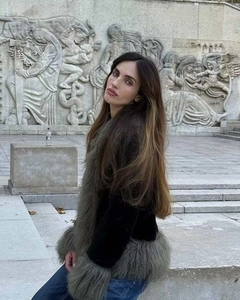 Detail view of stylish black velvet jacket featuring grey faux fur trim and collar