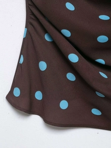 Close-up of brown chiffon fabric with light blue polka dots and rolled hem stitching detail
