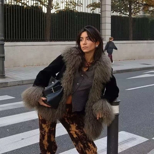 Women's autumn velvet jacket with oversized faux fur collar and cuffs on street background