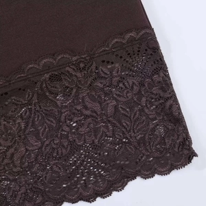 Detailed view of dark brown fabric featuring intricate floral lace trim on the bottom hemline