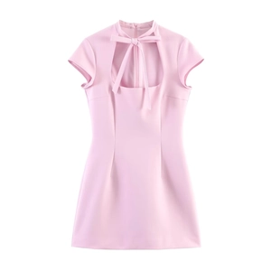 Detail of light pink slim-fit mini dress featuring a bow-tie neck and chest cutout