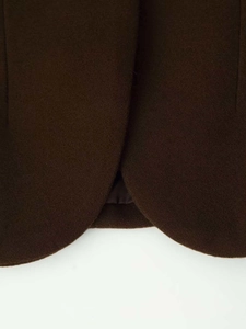 Macro detail of high-quality dark chocolate brown wool fabric with smooth inner lining