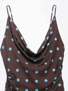 Detail of cowl neck dress in dark brown with light blue polka dots and side ruching
