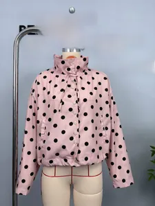 Detail of pink polka dot long sleeve jacket with high collar drawstring and white buttons