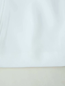 Macro detail of white woven fabric texture and high-quality hem stitching on the top
