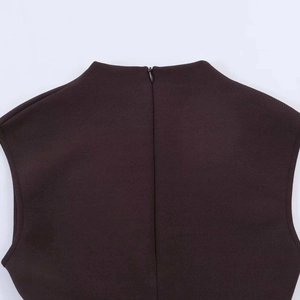 Detail showing the invisible back zipper and high neckline of the brown lace dress