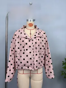 Detail of pink polka dot long sleeve jacket with button closure and elastic hem