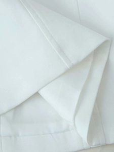 Detailed macro view showing high-quality white twill fabric texture and clean stitching