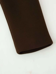 Detailed close-up of dark brown woolen fabric texture and premium seamless stitching finish