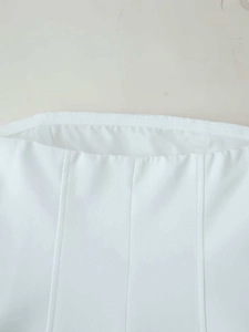 Close-up of white strapless top featuring vertical seams and high-quality woven fabric texture