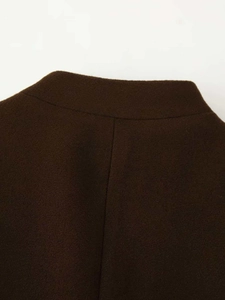 Detailed close-up of the center seam and soft wool texture of the dark brown skirt set