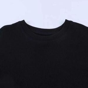 Detail of the crew neck collar on a black knit T-shirt with fine ribbed edge stitching