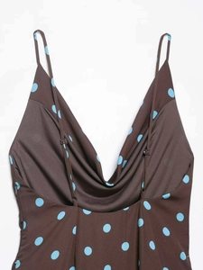 Detail of deep V-neckline on brown and blue polka dot camisole dress with adjustable straps
