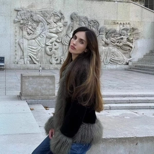Short black velvet jacket with gray faux fur trim and denim jeans in a retro street style