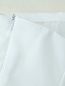 Detail of hidden zipper closure on white high-density woven fabric of the summer top