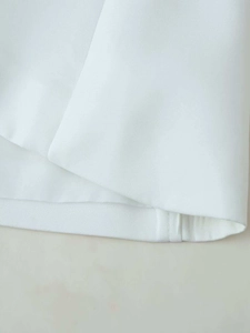 Detailed close-up showing the professional stitching and texture of white fabric top