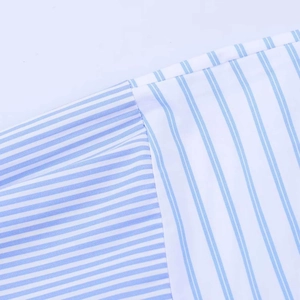 Detailed macro view of the blue and white striped poplin fabric patchwork and stitching