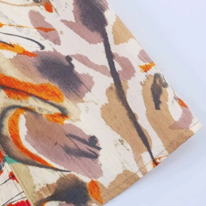 Detail shot of the abstract artistic print on textured summer dress fabric