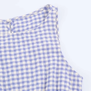 Detailed view of the back collar with button closure on a blue gingham midi dress