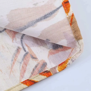Close-up of puff sleeve floral midi dress fabric with warm orange abstract patterns
