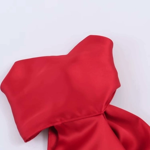 Close-up of red satin fabric detail and lace stitching on a sexy summer camisole top