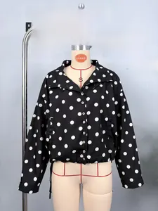 Detailed macro shot of polka dot jacket hem showing adjustable drawstring and fabric texture