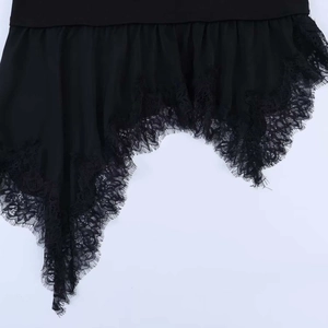Detailed macro view of the black asymmetric hemline featuring delicate eyelash lace trim
