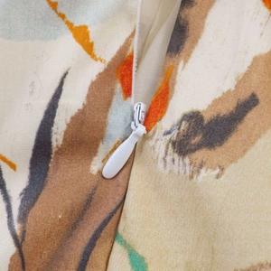 Detail of invisible white zipper and abstract floral print on summer midi dress fabric