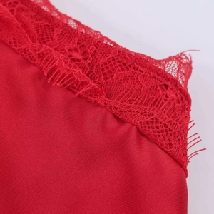 Detail shot of the glossy red satin fabric with exquisite matching lace embroidery edges