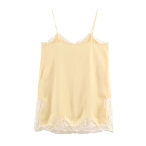 Pale yellow satin camisole with white lace trim and V-neckline on a white background