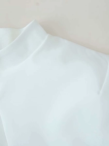 Close-up of the mock neck stitching and premium cotton texture on a white top